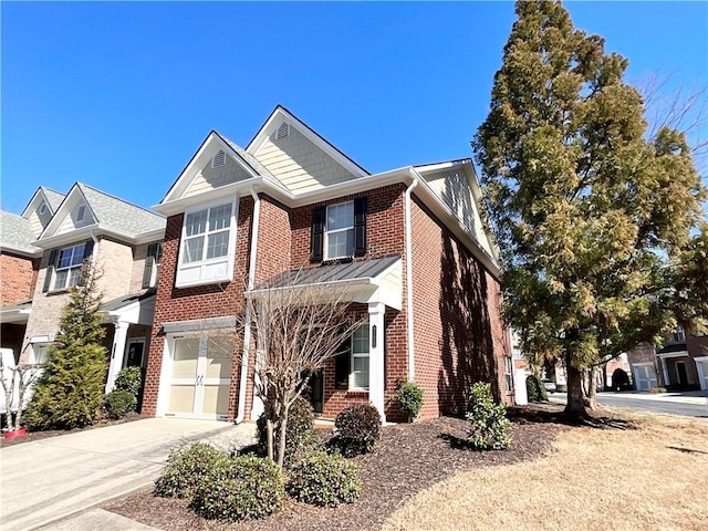 view of front of property featuring brick siding, driveway, and an attached garage