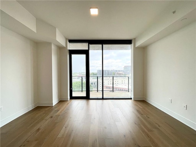 788 W Marietta St NW Unit 512, Atlanta, GA 30318 - spare room featuring wood finished floors, healthy amount of natural light, and floor to ceiling windows