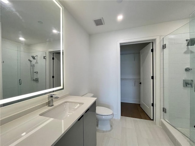 788 W Marietta St NW Unit 512, Atlanta, GA 30318 - bathroom featuring vanity, a shower stall, a walk in closet, and recessed lighting