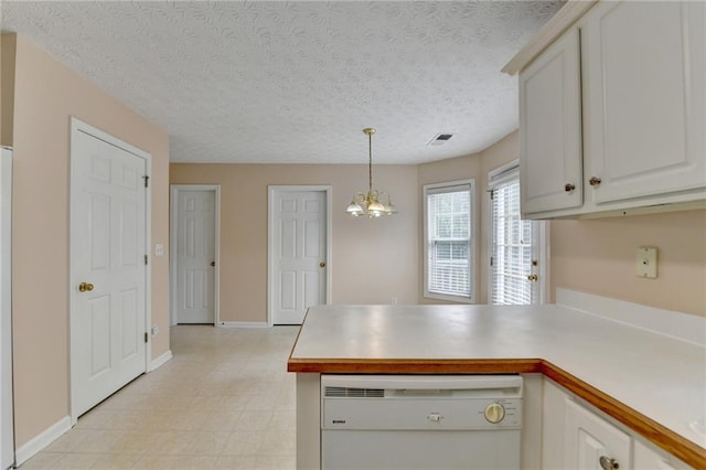 kitchen featuring dishwasher, a peninsula, light flooring, light countertops, and white cabinets