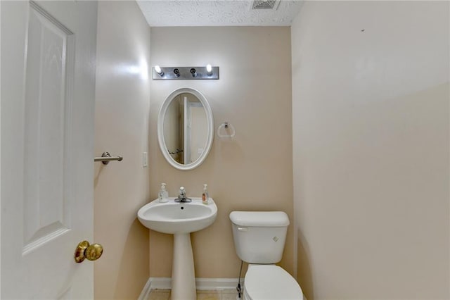 half bath with toilet and baseboards