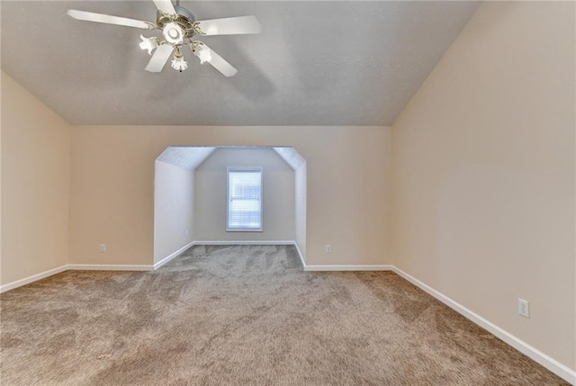 bonus room with carpet floors, lofted ceiling, baseboards, and ceiling fan