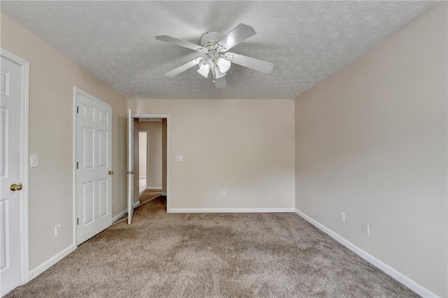 unfurnished bedroom featuring carpet floors, a textured ceiling, baseboards, and ceiling fan