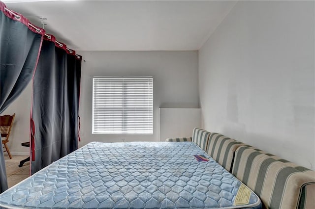 bedroom with light tile patterned floors