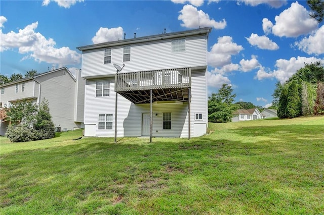 back of house featuring a yard and a wooden deck