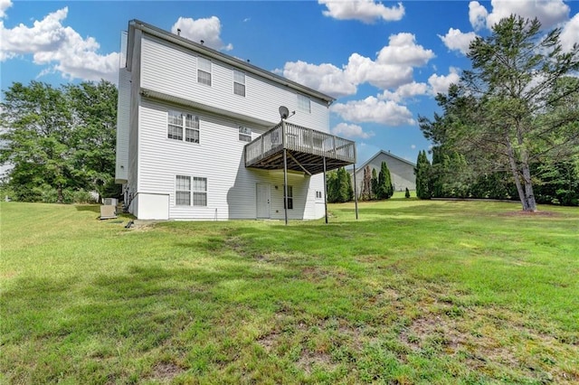 back of property featuring a yard and a wooden deck
