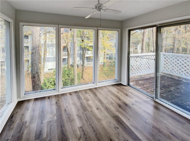 unfurnished sunroom featuring ceiling fan