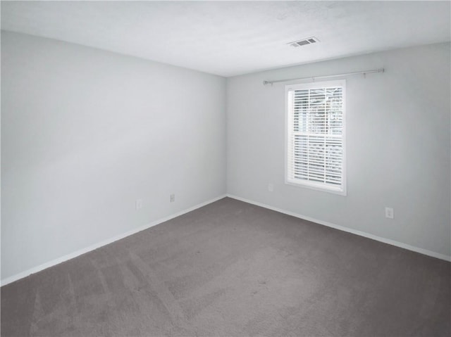 empty room featuring dark colored carpet