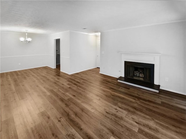 unfurnished living room with dark wood-type flooring and an inviting chandelier