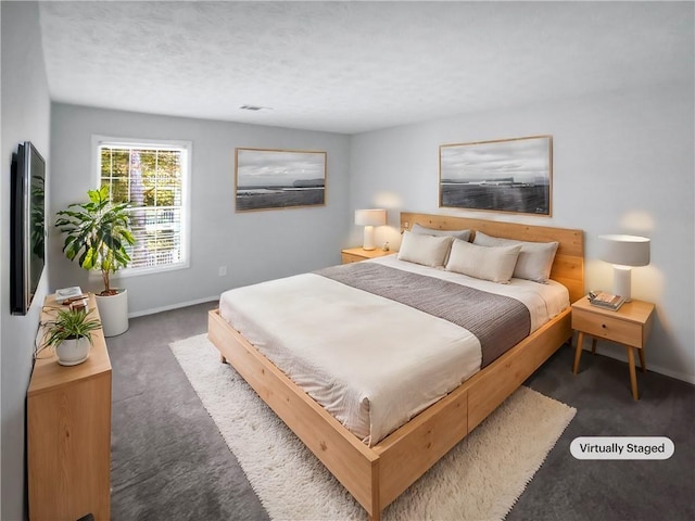 bedroom featuring dark carpet