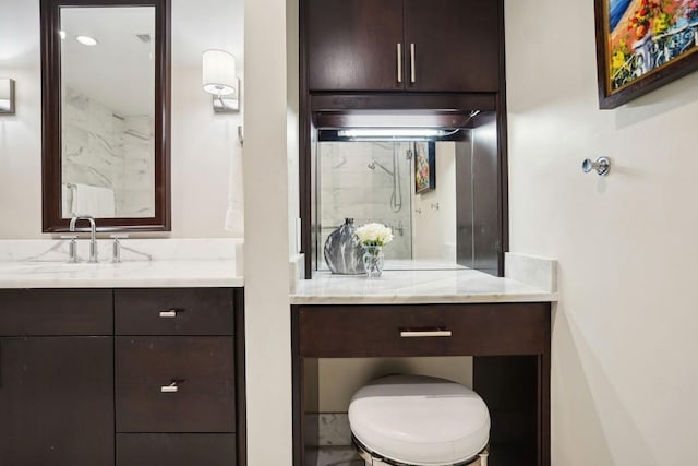 bathroom featuring a shower and vanity