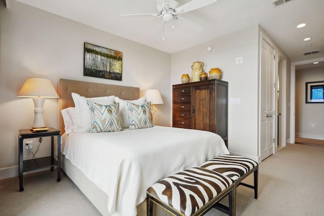 bedroom featuring ceiling fan and light carpet