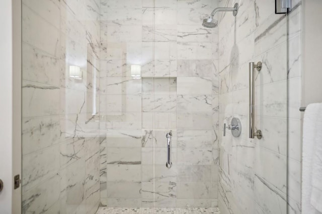 bathroom featuring a shower with shower door