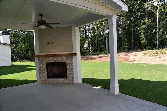 view of patio / terrace with an outdoor brick fireplace and a ceiling fan