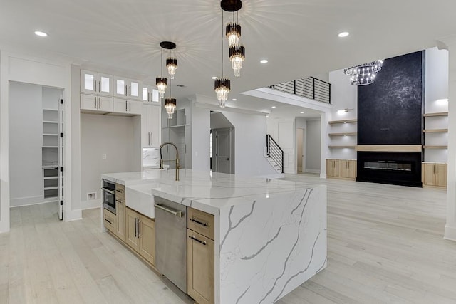 kitchen featuring recessed lighting, appliances with stainless steel finishes, a sink, and light wood-style flooring