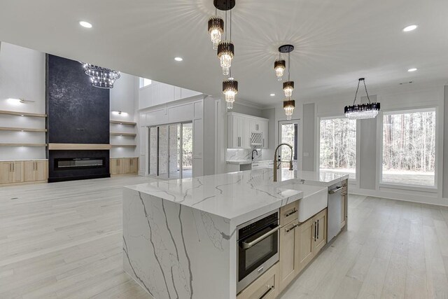 kitchen with an inviting chandelier, a healthy amount of sunlight, stainless steel appliances, and a sink