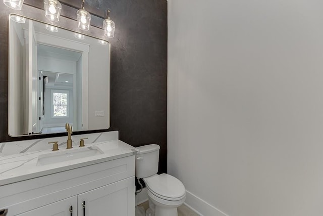 bathroom with toilet and vanity