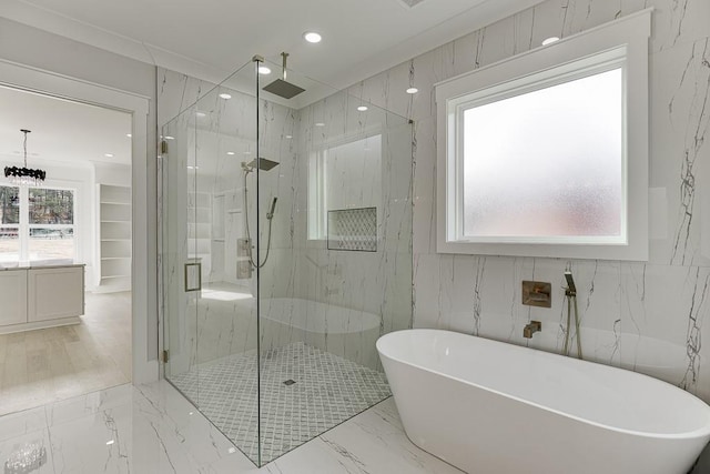 full bathroom featuring a freestanding tub, a marble finish shower, recessed lighting, and marble finish floor