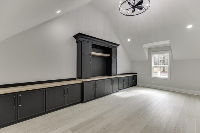 bonus room with recessed lighting, lofted ceiling, light wood finished floors, an inviting chandelier, and baseboards