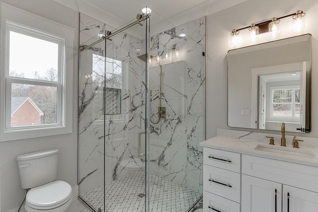bathroom featuring toilet, vanity, and a marble finish shower