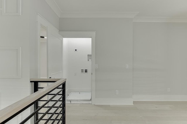 corridor featuring light wood-type flooring, baseboards, an upstairs landing, and crown molding