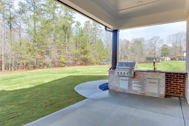 view of patio / terrace with an outdoor kitchen, a sink, and a grill