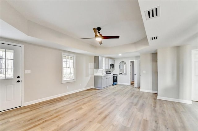 5702 Brynwood Cir NW, Acworth, GA 30101 - unfurnished living room with a ceiling fan, baseboards, and light wood finished floors