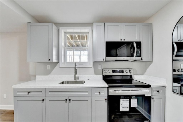 kitchen featuring a sink, appliances with stainless steel finishes, and light countertops