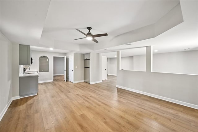 5702 Brynwood Cir NW, Acworth, GA 30101 - unfurnished living room featuring ceiling fan, baseboards, light wood-style flooring, and recessed lighting