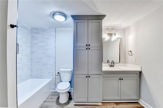 5702 Brynwood Cir NW, Acworth, GA 30101 - bathroom with toilet, wood finished floors, vanity,  shower combination, and baseboards
