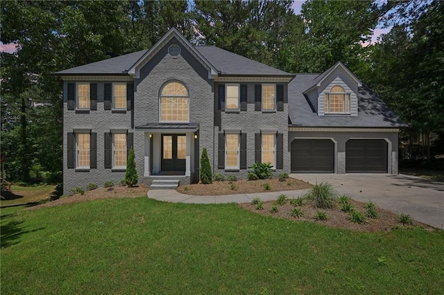 5702 Brynwood Cir NW, Acworth, GA 30101 - colonial home featuring concrete driveway, french doors, a front lawn, a garage, and brick siding
