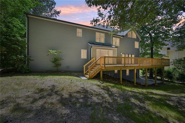 5702 Brynwood Cir NW, Acworth, GA 30101 - back of property at dusk with a wooden deck and stairway