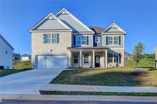 craftsman-style home with a front lawn and a garage