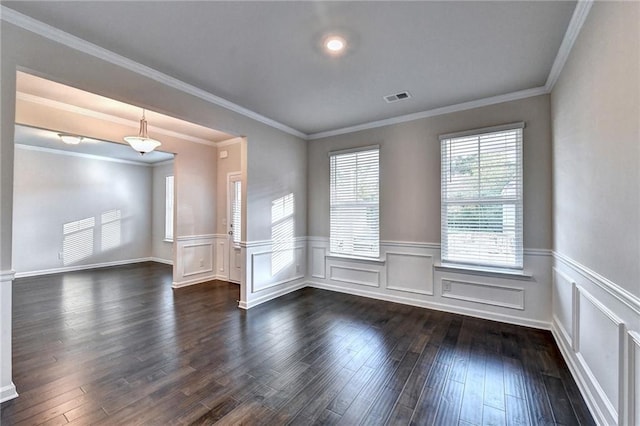 spare room featuring dark hardwood / wood-style flooring and crown molding