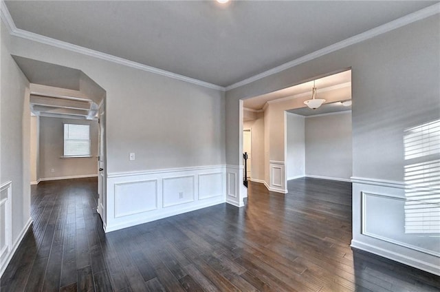 spare room with dark hardwood / wood-style floors and ornamental molding