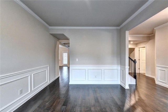 empty room featuring dark hardwood / wood-style floors and crown molding