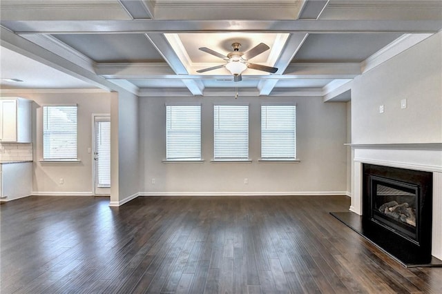 unfurnished living room with beam ceiling, ceiling fan, coffered ceiling, and ornamental molding