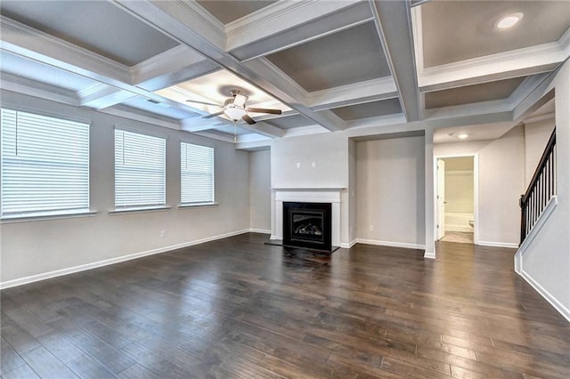 unfurnished living room featuring beam ceiling, ornamental molding, and coffered ceiling