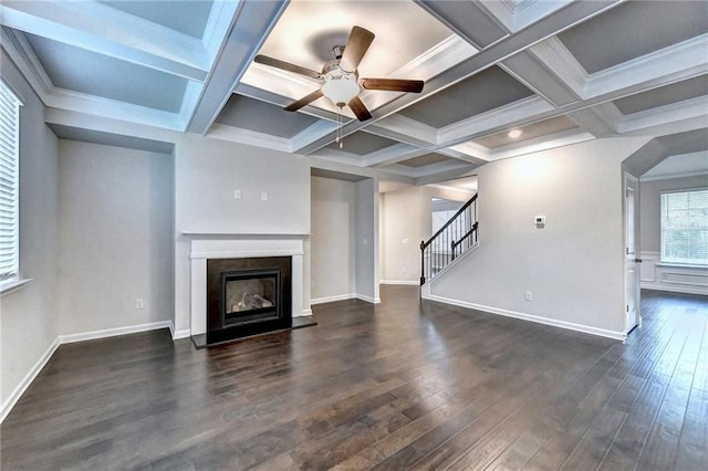 unfurnished living room with beam ceiling, ornamental molding, ceiling fan, and coffered ceiling