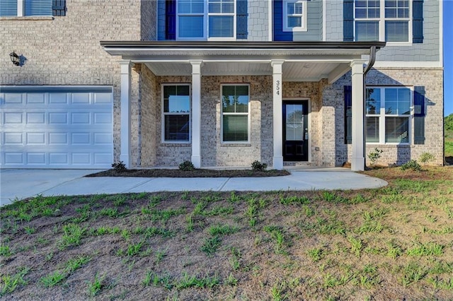 doorway to property with a porch and a garage