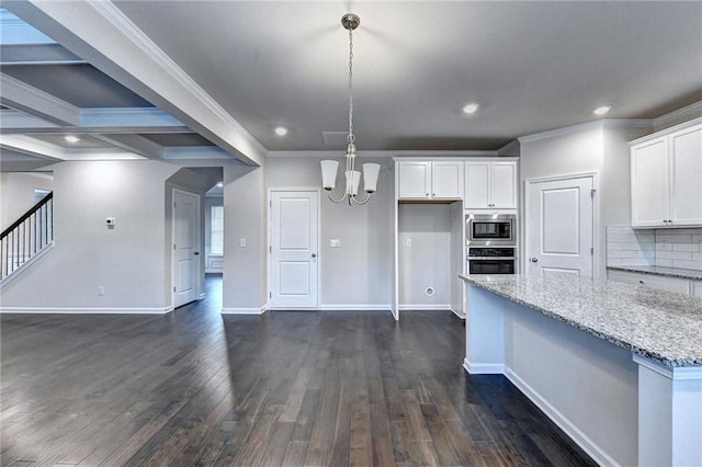 kitchen with light stone countertops, appliances with stainless steel finishes, white cabinets, and beamed ceiling