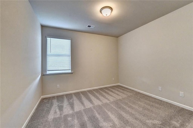 unfurnished room featuring light carpet