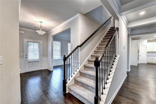 foyer with crown molding and dark hardwood / wood-style floors