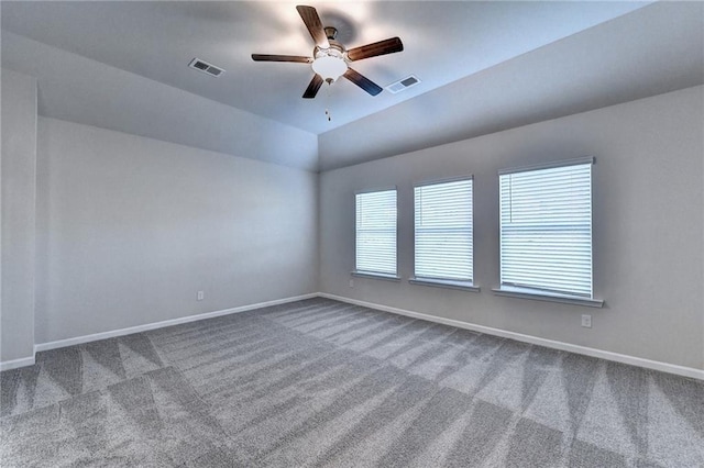 unfurnished room with ceiling fan, carpet, and vaulted ceiling