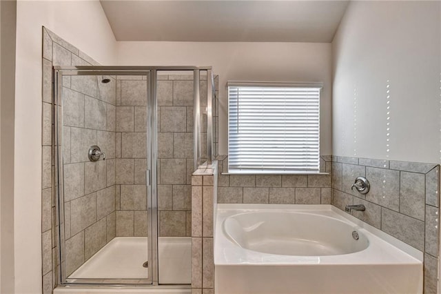 bathroom with lofted ceiling and independent shower and bath