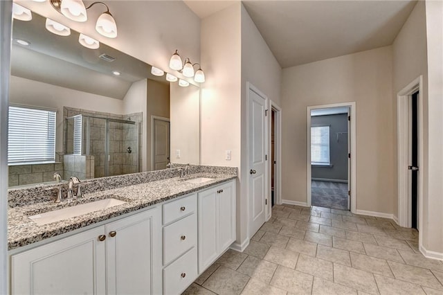 bathroom featuring plenty of natural light, vanity, a shower with door, and tile patterned flooring