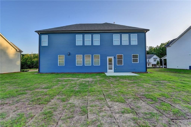back of property featuring a patio area and a yard