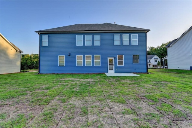 back of property featuring a lawn and a patio