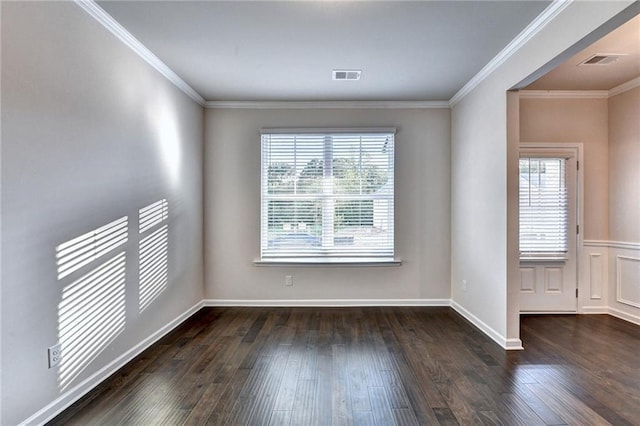 spare room with dark wood-type flooring and ornamental molding