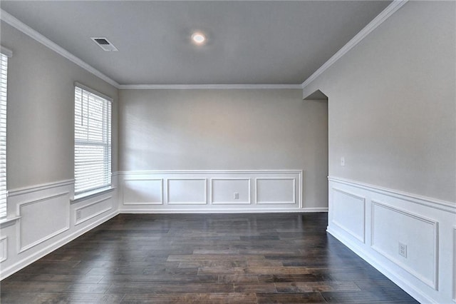 spare room featuring dark hardwood / wood-style floors and ornamental molding